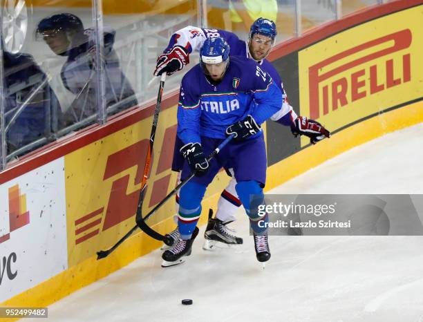 Ben Oconnor of Great Britain competes for the puck with Diego Kostner of Italy during the 2018 IIHF Ice Hockey World Championship Division I Group A...