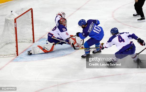 Giulio Scandella of Italy scores the their equaliser among goalie Ben Bowns of Great Britain and Stephen Lee of Great Britain during the 2018 IIHF...