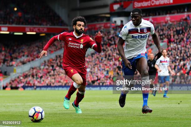 Mohamed Salah of Liverpool and Kurt Zouma of Stoke City in action during the Premier League match between Liverpool and Stoke City at Anfield on...