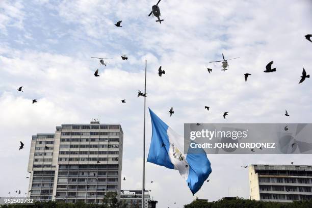 The Guatemalan flag waves at half-mast during a ceremony to honour late Guatemala's City Mayor and former Guatemalan President Alvaro Arzu, during...