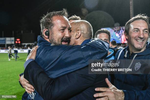 Agen's head coach Stephane Prosper celebrates with other staff members winning the French Top 14 rugby union match between SU Agen and ASM Clermont...