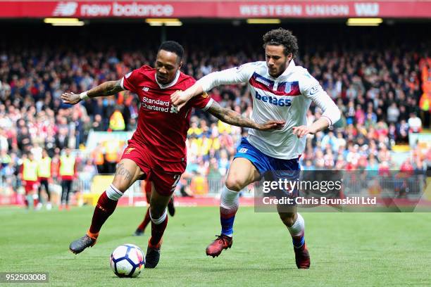 Nathaniel Clyne of Liverpool is challenged by Ramadan Sobhi Ahmed of Stoke City during the Premier League match between Liverpool and Stoke City at...