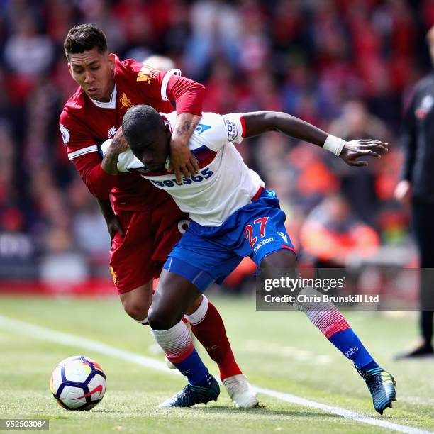 Badou Ndiaye of Stoke City is challenged by Roberto Firmino of Liverpool during the Premier League match between Liverpool and Stoke City at Anfield...