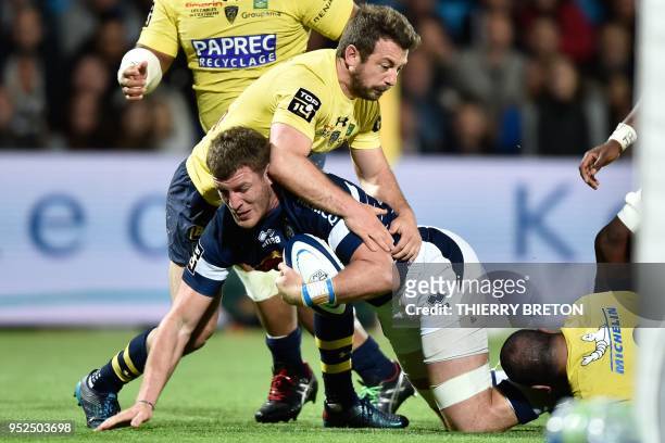 Agen's flanker Antoine Erbani is tackled during the French Top 14 rugby union match between SU Agen and ASM Clermont on April 28 2018 at the Armandie...
