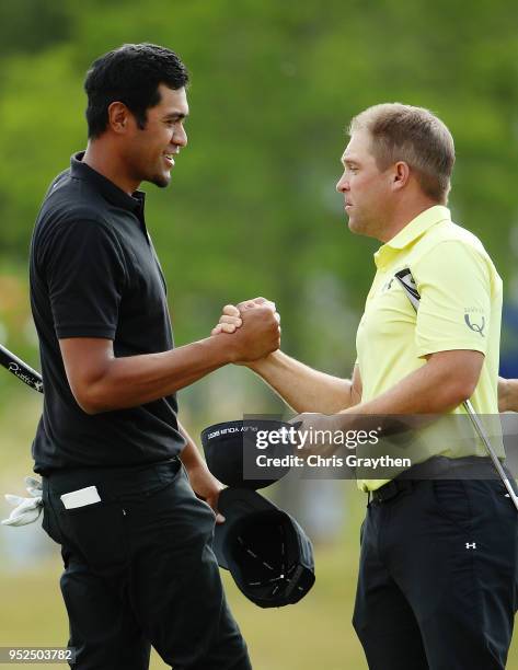 Tony Finau and Daniel Summerhays shake hands after their round on the 18th hole during the third round of the Zurich Classic at TPC Louisiana on...