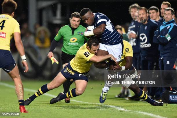 Agen's Fijian winger Filipo Nakosi is tackled by Clermont's scrumhalf Morgan Parra during the French Top 14 rugby union match between SU Agen and ASM...