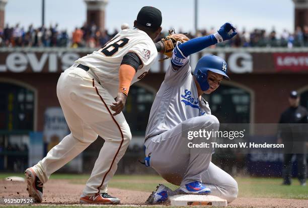 Joc Pederson of the Los Angeles Dodgers slides into third base with an RBI triple, beating the throw to Pablo Sandoval of the San Francisco Giants in...
