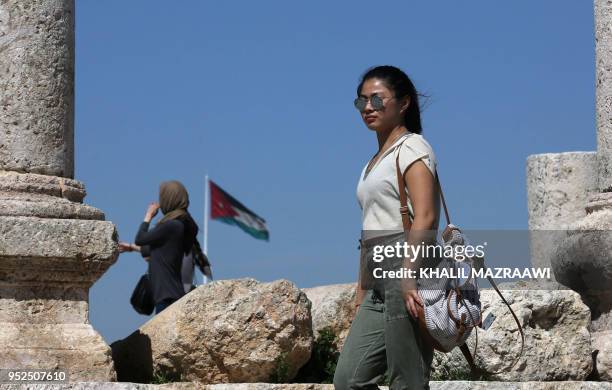 Tourists visit the Amman Citadel in the Jordanian capital on March 13, 2018. - With its rock-hewn ancient city of Petra, lunar-like landscape of Wadi...