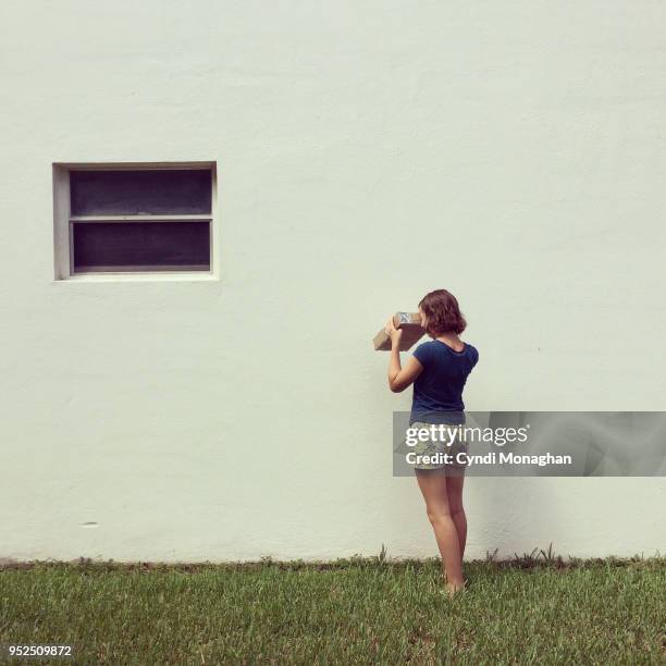 girl looking through pinhole projector to watch eclipse - pinhole camera stock pictures, royalty-free photos & images