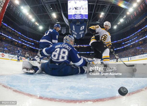 Goalie Andrei Vasilevskiy of the Tampa Bay Lightning gives up a goal against Brad Marchand of the Boston Bruins during Game One of the Eastern...