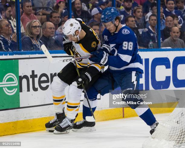 Mikhail Sergachev of the Tampa Bay Lightning against Sean Kuraly of the Boston Bruins during Game One of the Eastern Conference Second Round during...