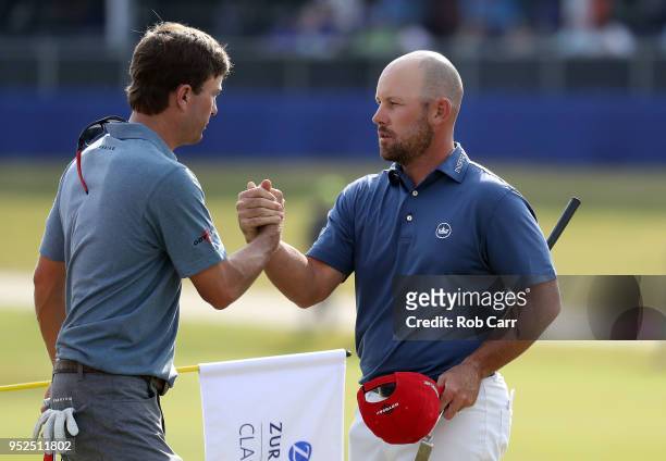 Kevin Kisner and Scott Brown shake hands as they finish their round on the 18th green during the third round of the Zurich Classic at TPC Louisiana...