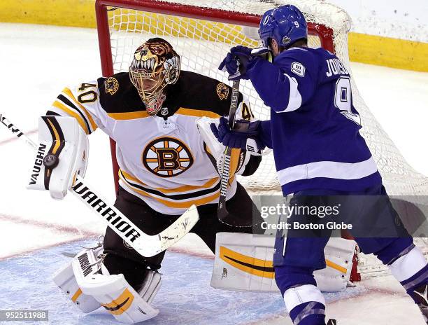 Boston Bruins goaltender Tuukka Rask makes a blocker save as Tampa Bay Lightning center Tyler Johnson is unable to get to the rebound during the...