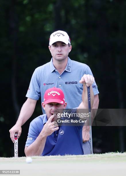 Kevin Kisner nd Scott Brown line up a putt during the third round of the Zurich Classic at TPC Louisiana on April 28, 2018 in Avondale, Louisiana.