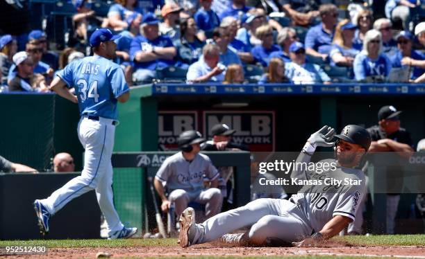 The Chicago White Sox's Yoan Moncada scores in front of Kansas City Royals starting pitcher Trevor Oaks on a three-run double Yolmer Sanchez in the...