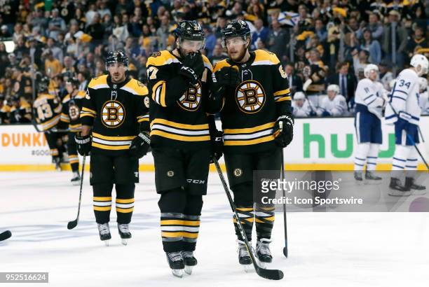 Boston Bruins center Patrice Bergeron and Boston Bruins right wing David Pastrnak discuss a face off in the offensive zone during Game 5 of the First...