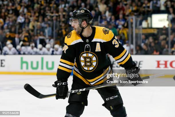 Boston Bruins center Patrice Bergeron checks with the point before a face off in the offensive zone during Game 5 of the First Round for the 2018...