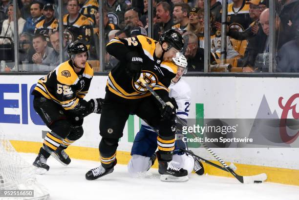 Boston Bruins center Sean Kuraly takes the puck from Toronto Maple Leafs defenseman Travis Dermott during Game 5 of the First Round for the 2018...