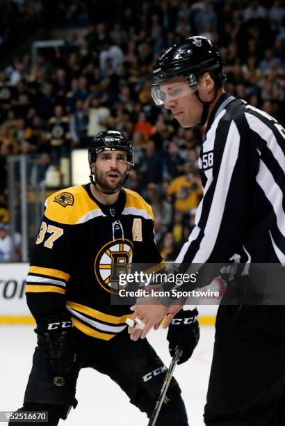 Boston Bruins center Patrice Bergeron reacts after being tossed from the circle by linesman Ryan Gibbons during Game 5 of the First Round for the...