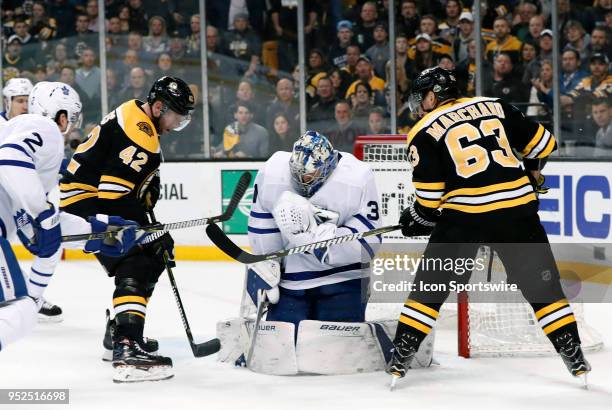 Toronto Maple Leafs goalie Frederik Andersen holds on with Boston Bruins center David Backes and Boston Bruins left wing Brad Marchand in front...