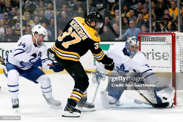 Boston Bruins center Patrice Bergeron and Toronto Maple Leafs goalie Frederik Andersen go for the puck during Game 5 of the First Round for the 2018...