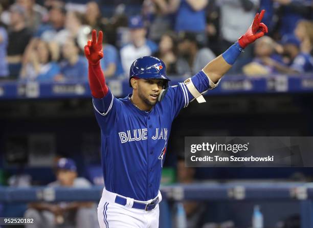 Lourdes Gurriel Jr. #13 of the Toronto Blue Jays celebrates after hitting his first career MLB home run a solo shot in the seventh inning during MLB...