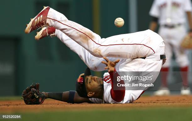 Eduardo Nunez of the Boston Red Sox attempts to throw the ball to first as he falls in the eighth inning on a ball hit by Jesus Sucre of the Tampa...