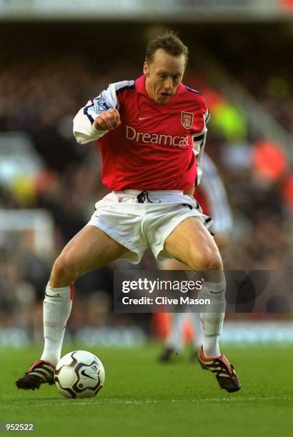 Lee Dixon of Arsenal runs with the ball during the FA Carling Premiership match against Chelsea played at Highbury, in London. The match ended in a...