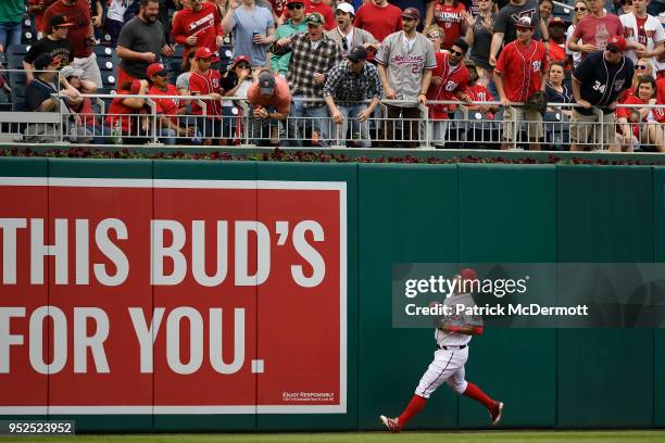 Moises Sierra of the Washington Nationals watches a fan in the stands catch David Peralta of the Arizona Diamondbacks solo home run in the fourth...