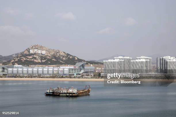 Boat sails past the Dalian Wanda Group Co. Oriental Movie Metropolis film production hub in in Qingdao, China, on Tuesday, April 17, 2018. Wanda, a...