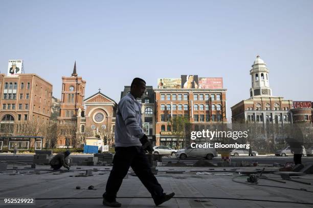 Pedestrians walk past a film set resembling Shanghai architecture from the 1920s at a backlot of the Dalian Wanda Group Co. Oriental Movie Metropolis...