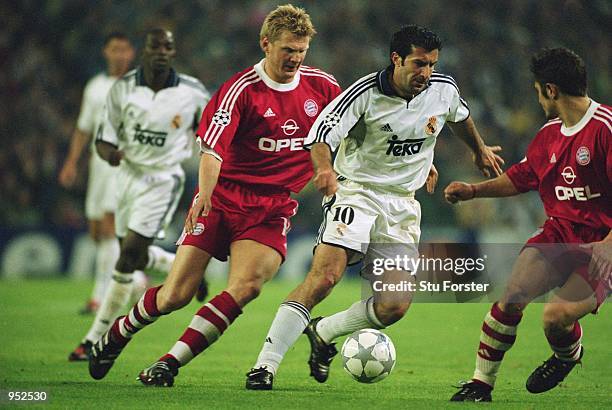 Luis Figo of Real Madrid takes the ball past Stefan Effenberg and Bixente Lizarazu of Bayern Munich during the UEFA Champions League Semi-Final first...