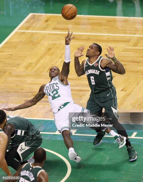 Terry Rozier of the Boston Celtics falls taking a shot against Eric Bledsoe of the Milwaukee Bucks during the second quarter of Game Seven in Round...