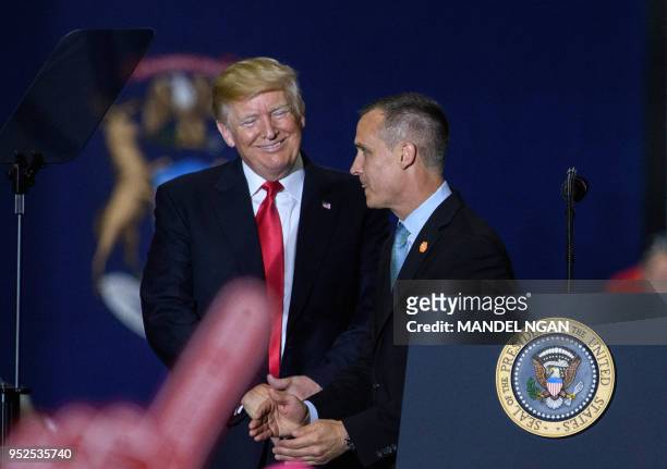 Former Trump Campaign manager Corey Lewandowski speaks as US President Donald Trump looks on during a rally at Total Sports Park in Washington,...
