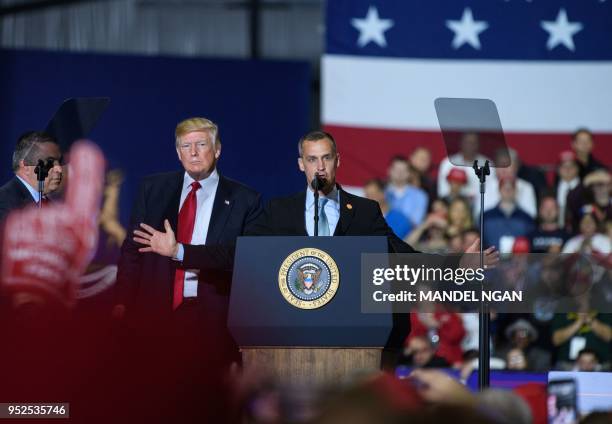 Former Trump Campaign manager Corey Lewandowski speaks as US President Donald Trump looks on during a rally at Total Sports Park in Washington,...