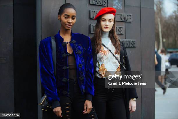 Models Tami Williams, Greta Varlese after the Chanel show on March 06, 2018 in Paris, France. Tami wears a blue oriental-style jacket. Greta wears a...