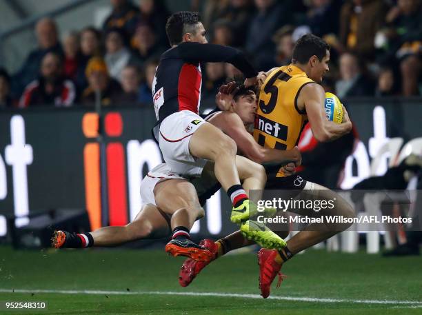 Ryan Burton of the Hawks is tackled by Jack Steele of the Saints and Jade Gresham of the Saints during the 2018 AFL round six match between the...