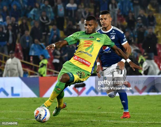 Carlos Ramirez of Atletico Huila fights for the ball with Ayron del Valle of Millonarios during a match between Millonarios and Atletico Huila at...