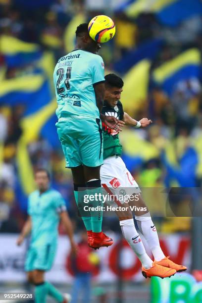 Jorge Tavares of Santos Laguna heads the ball over Joe Corona of America during the 17th round match between America and Santos Laguna as part of the...