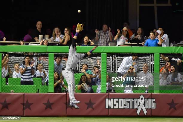 Gerardo Parra of the Colorado Rockies robs J.T. Realmuto of the Miami Marlins of a home run in the seventh inning of the game at Marlins Park on...