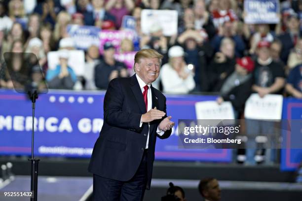 President Donald Trump applauds as he arrives to speak at a rally in Washington, Michigan, U.S., on Saturday, April 28, 2018. Trump took on most of...