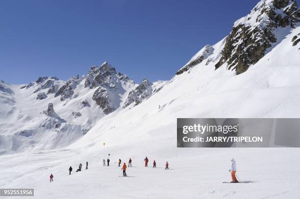The blue easy ski slope Anemones with Saulire and La Croix des Verdons mountains, Courchevel 1850 ski resort, Trois Vallees skiing area, Tarentaise...