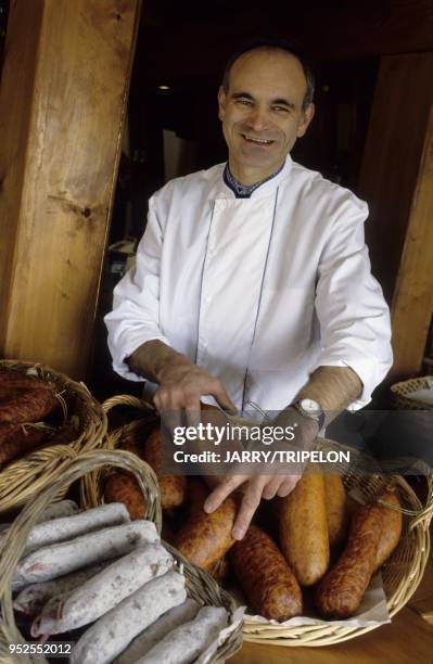 Gerard Marguet showing sausages with cabbage, sausages of Morteau and dry sausages in the ashes, Tuye of Papy Gaby, smoked meats in the tuye, village...