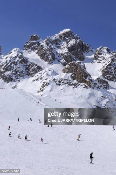 The red difficult ski slope Combe Saulire withe Saulire and La Croix des Verdons mountains, Courchevel 1850 ski resort, Trois Vallees skiing area,...