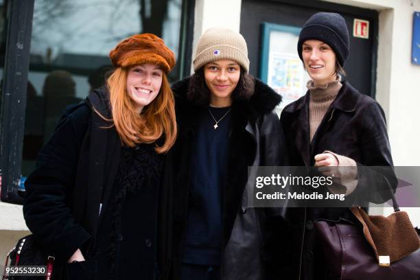 Models Kiki Willems, Binx Walton, Marte Mei Van Haaster after the Dior show on March 27, 2018 in Paris, France.All three models wear hats and black...