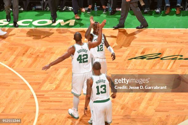 Terry Rozier of the Boston Celtics and Al Horford of the Boston Celtics high-five after the game against the Milwaukee Bucks in Game Seven of the...