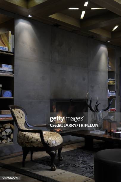 Lounge fireplace, Cheval Blanc Hotel and Palace 5 stars, located in Jardin Alpin district, Courchevel 1850 ski resort, Trois Vallees skiing area,...