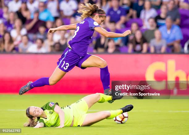 Orlando Pride forward Alex Morgan leaps over Seattle Reign FC defender Kristen McNabb to try and score during the NWSL soccer match between the...