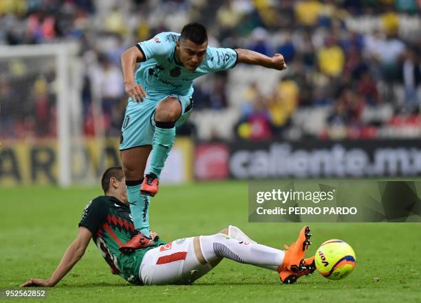 Santos midfielder Osvaldo Martinez vies for the ball with America's defender Paul Aguilar during their Mexican Clausura tournament football match at...