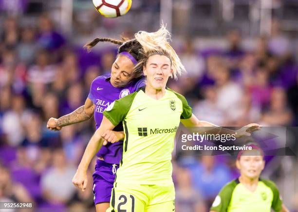 Orlando Pride forward Sydney Leroux and Seattle Reign FC defender Christen Westphal challenge for a header during the NWSL soccer match between the...